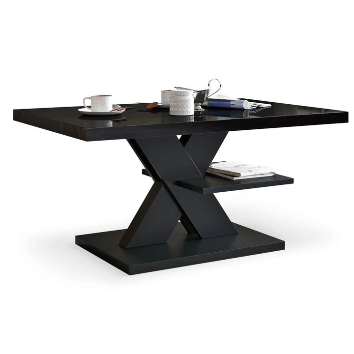 A glossy black coffee table with an X-shaped base, smooth top, and integrated storage shelf for added functionality.